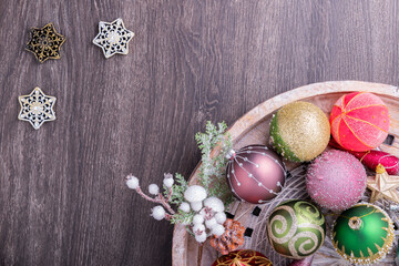 Fototapeta na wymiar Set of Christmas decorations in wooden tray on grunge background. Holiday concept. Flat lay, top view