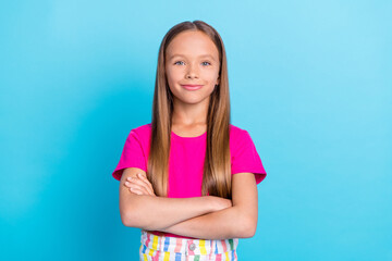 Photo of cheerful young happy confident small girl hold hands crossed isolated on pastel blue color background