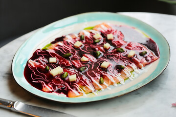 Salmon with beetroot sauce and pistachios