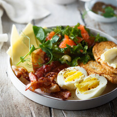 Hard boiled egg, salad and toast for breakfast