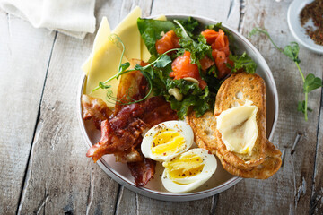 Hard boiled egg, salad and toast for breakfast