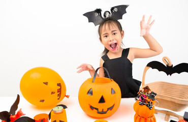 Cute girl is screaming with balloons, pumpkins, Halloween celebrating happy Thanksgiving day.