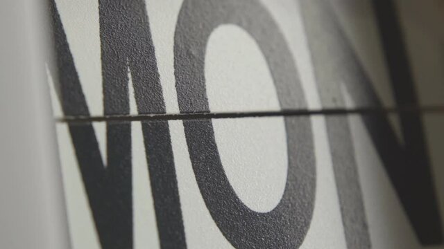 Close-up shot of days of the week on flip calendar clock