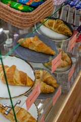 Fresh croissants on display in Russia, sweet with raspberries and almonds and nuts and chocolate and buttercream and not sweet with cheese a large amount