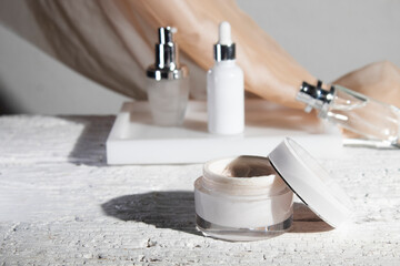 white wood table background with fabric textile, cosmetic makeup bottle lotion cream product with beauty fashion skincare healthcare mockup