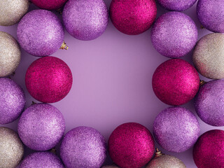 Pink, gold and purple glitter Christmas balls with copy space. Flat lay, top view. Christmas, winter, new year concept.