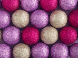 Pink, gold and purple glitter Christmas balls pattern. Flat lay, top view. Christmas, winter, new year concept.