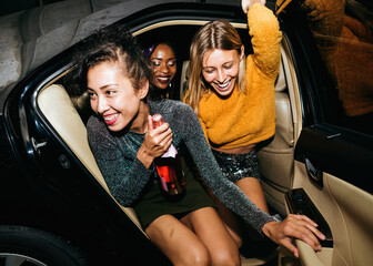 Diverse women in a backseat of a cab