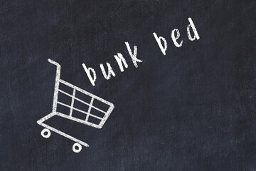 Chalk drawing of shopping cart and word bunk bed on black chalboard. Concept of globalization and mass consuming