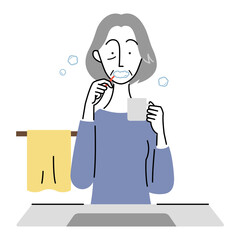 歯磨きをするシニア女性