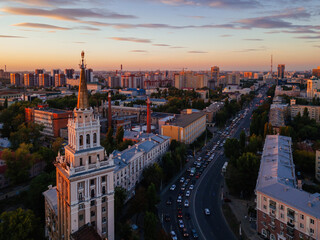 Obraz premium Evening summer Voronezh cityscape. Tower in architecture Stalinist empire at crimson sunset