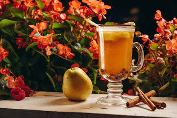 Hot drink cocktail for New Year, Christmas, winter or autumn holidays. Toddy. Mulled pear cider or...