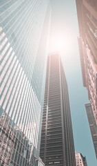 Looking up at New York skyscrapers, color toning applied, USA.