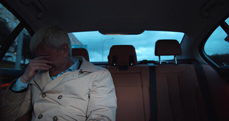 Stressed sad aged man crying in backseat of taxi © nimito