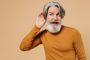 Elderly gray-haired mustache bearded man 50s in mustard yellow turtleneck shirt try to hear you...