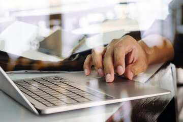 Close up image of Man typing on laptop keyboard 