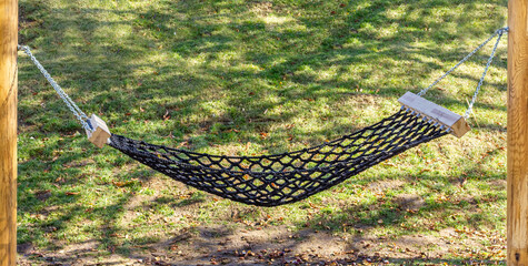 Wicker hammock in the backyard. Public space. Resting-place.