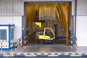 Naklejka premium Forklift parking at logistics warehouse, forklift loader pallet stacker truck equipment at warehouse