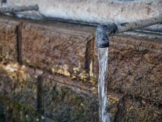 Clean drinking water flows continuously from the tap of a natural source. Lack of clean drinking water. Drought.