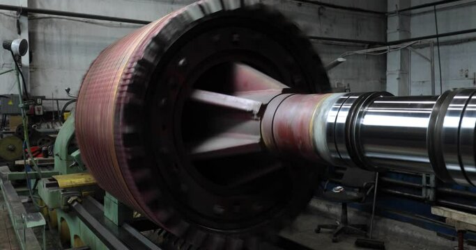 Huge electric motor spinning at the production shop of the factory