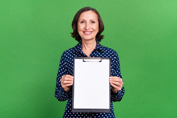 Photo of lovely aged lady hold paper wear blue blouse isolated on green color background