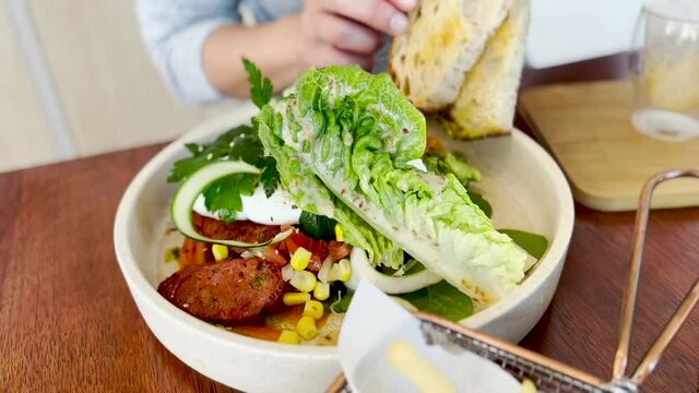 A healthy brunch of chorizo salad and chicken burger in a cafe, Sydney NSW Australia 