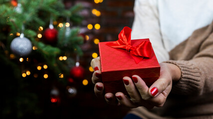 Woman holding gift box in hands. Christmas, New Year, birthday concept