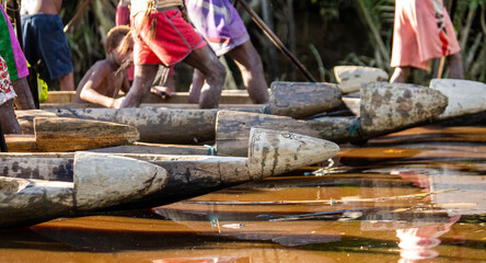 Fragments of canoe warriors of the Asmat tribe on the river.