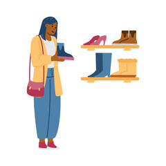 Beautiful African woman stands in front of shelves with shoes in shoe store