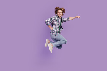 Full size profile side photo of young cheerful man jump run safe superman hero isolated over violet color background