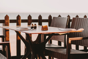 Reserved table at cafe. Empty cafe waiting for people. Golden hour light