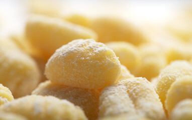 Raw italian gnocchi on a white background, close up