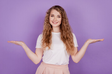 Photo of cheerful positive lady palms demonstrate blank space wear casual outfit on purple background