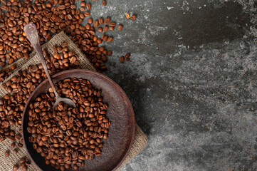 roasted coffee beans in an old vintage frying pan top shot. copy space