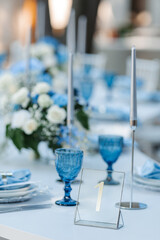 Wedding decor. Elegant table setup in blue pastels.