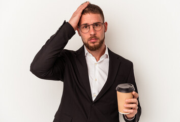 Naklejka premium Young business caucasian man holding take away coffee isolated on white background being shocked, she has remembered important meeting.