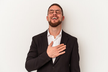 Young business caucasian man isolated on white background laughs out loudly keeping hand on chest.