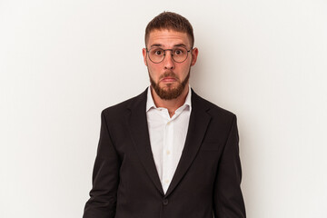 Young business caucasian man isolated on white background shrugs shoulders and open eyes confused.
