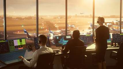 Diverse Air Traffic Control Team Working in a Modern Airport Tower at Sunset. Office Room is Full...
