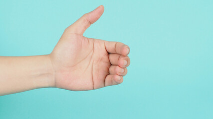 Empty Hand holding or catching guesture on green mint background.