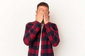 Young caucasian man with diastema isolated on white background afraid covering eyes with hands.