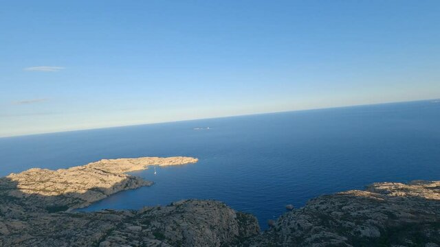 FPV video, mountain surfing, flying at high speed over a granite mountain during a sunny day. Caprera Island, La Maddalena archipelago, Sardinia, Italy.