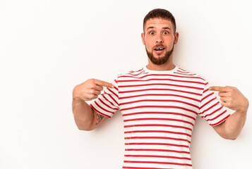 Young caucasian man with diastema isolated on white background points down with fingers, positive feeling.