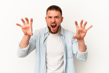 Young caucasian man with diastema isolated on white background showing claws imitating a cat, aggressive gesture.