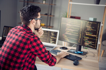 Profile side view portrait of attractive skilled focused guy writing html code css language php at...