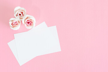 Blank white greeting card with pink rose flowers. Mock up.