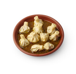 Portion of khinkali on clay plate isolated on white background