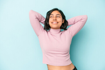 Young latin woman isolated on blue background feeling confident, with hands behind the head.