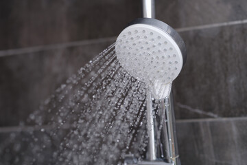 Splashing water from the mixer in the bathroom for a shower