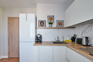 Fototapeta na wymiar white kitchen with Scandinavian-style dining area